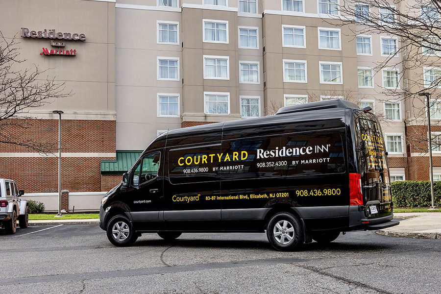 shuttle van parked outside hotel