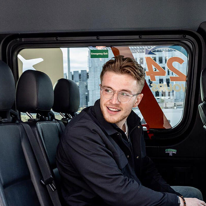 passenger smiling inside shuttle van