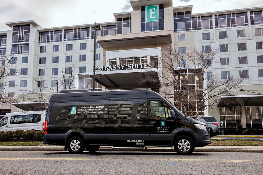 shuttle van parked outside hotel