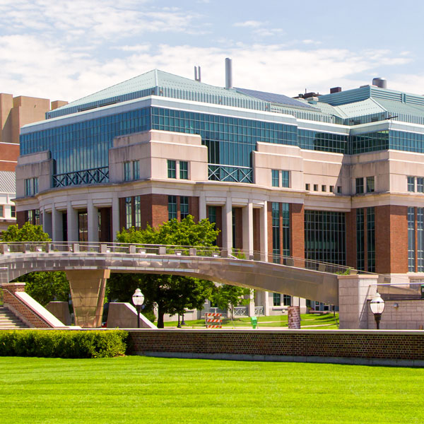 university campus with large building and green lawn