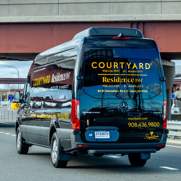 black shuttle van on highway