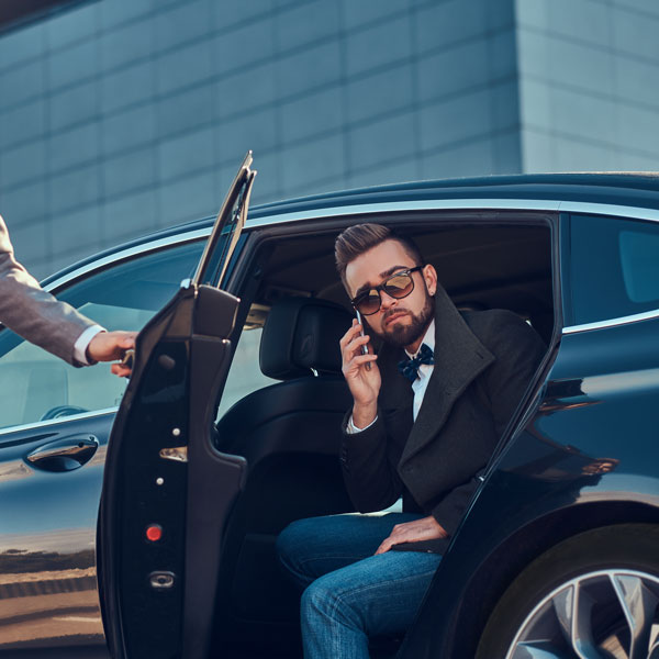 man getting out of luxury car